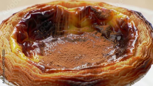 Detailed Close-Up of a Portuguese Pastel de Nata with Slightly Scorched Custard Surface, Showcasing Texture and Richness Ideal for Culinary Photography