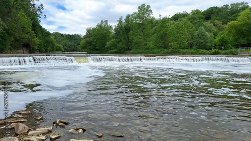 Photography A beautiful river flows over a scenic weir