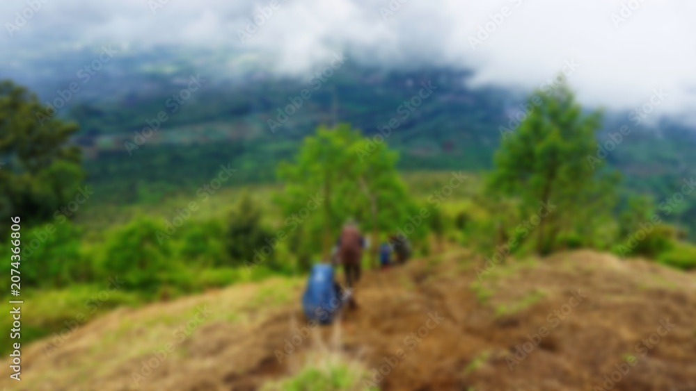 Obraz premium Blurred of People Hiking Down from Kembang Mountain Indonesia