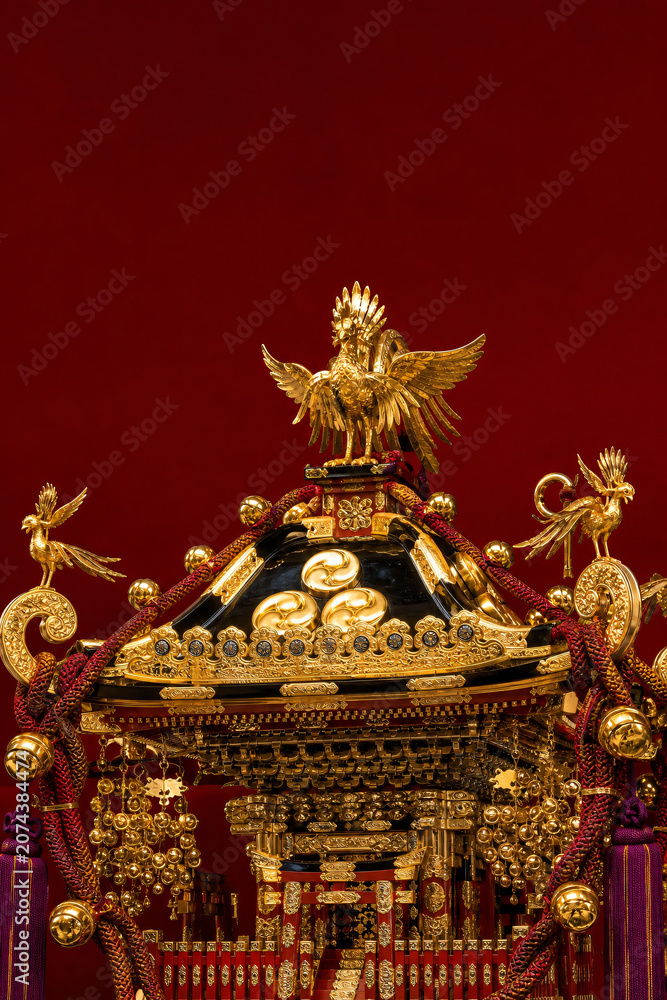 Fototapeta premium Ornate gold phoenix mikoshi portable shrine close-up intricate metalwork Japanese summer festival