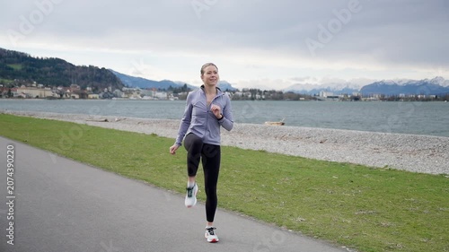 Athletic woman warming up and stretching before running outdoors
