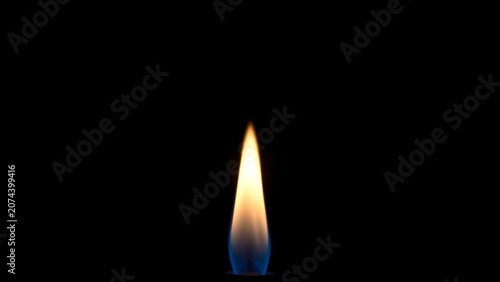 Steady blue flame burning against a dark, minimalist background.