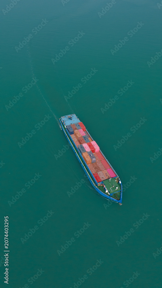 Fototapeta premium Aerial view from a container drone. Container ships in export-import and logistics business Transporting goods to large ports Worldwide shipping and logistics business International business abroad