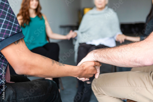 Tableau sur toile Group support through holding hands.