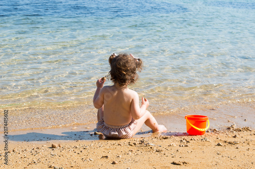 Toddler Sitting on a Sandy Adriatic Beach, Enjoying Summer by the Sea in Croatia