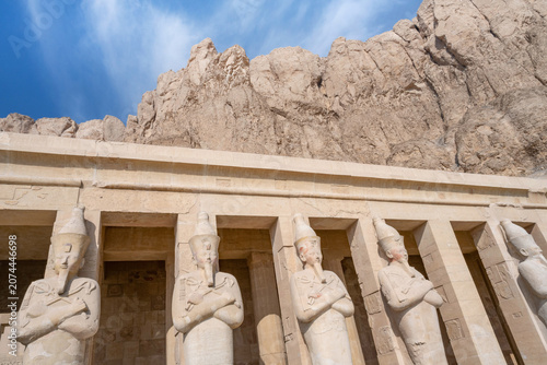Osiride statues of Hatshepsut, a standing statue of a pharaoh in the form of a mummy, set on the upper terrace of the Pharaoh Queen, Luxor, Egypt.