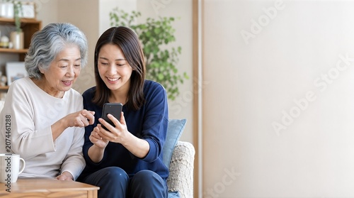 Young woman teaching elderly woman smartphone app