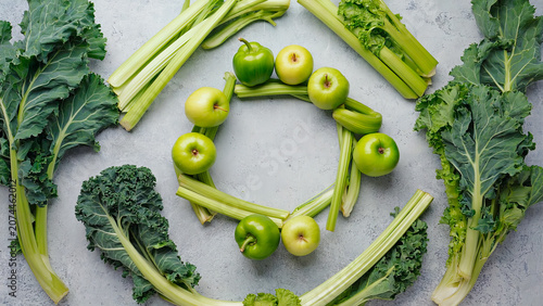 Composition of celery, kale, and green apples on a light background. Concept of detox, healthy eating, and fresh produce.
