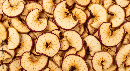 Dried apple slices, detailed top view, with brown and red color grading, perfect for healthy snacks, food blogs, and recipe illustrations