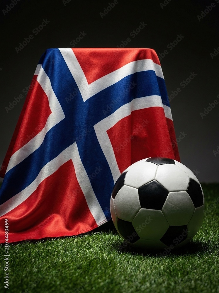 Fototapeta premium Norwegian flag and soccer ball on green grass