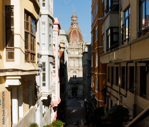 Street view with the Municipal Palace domes in La Coruna, Spain