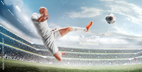 A soccer player kicks the ball in action. Large stadium full of fans. A professional soccer player scores the winning goal. A large stadium during the championship