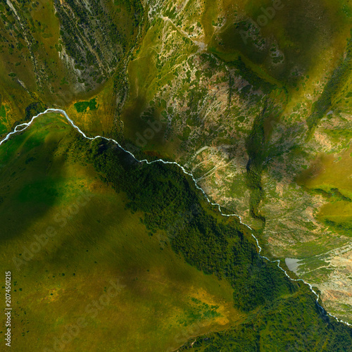 Photos Aerial View of Winding River Through Mountain Landscape