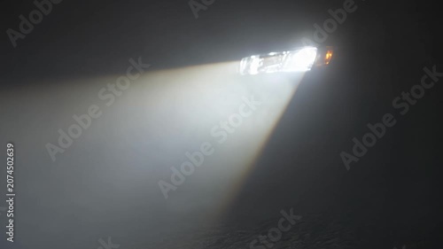 Car Headlight Beam Cutting Through Foggy Darkness Illustrating Discovery and Path Forward at Night