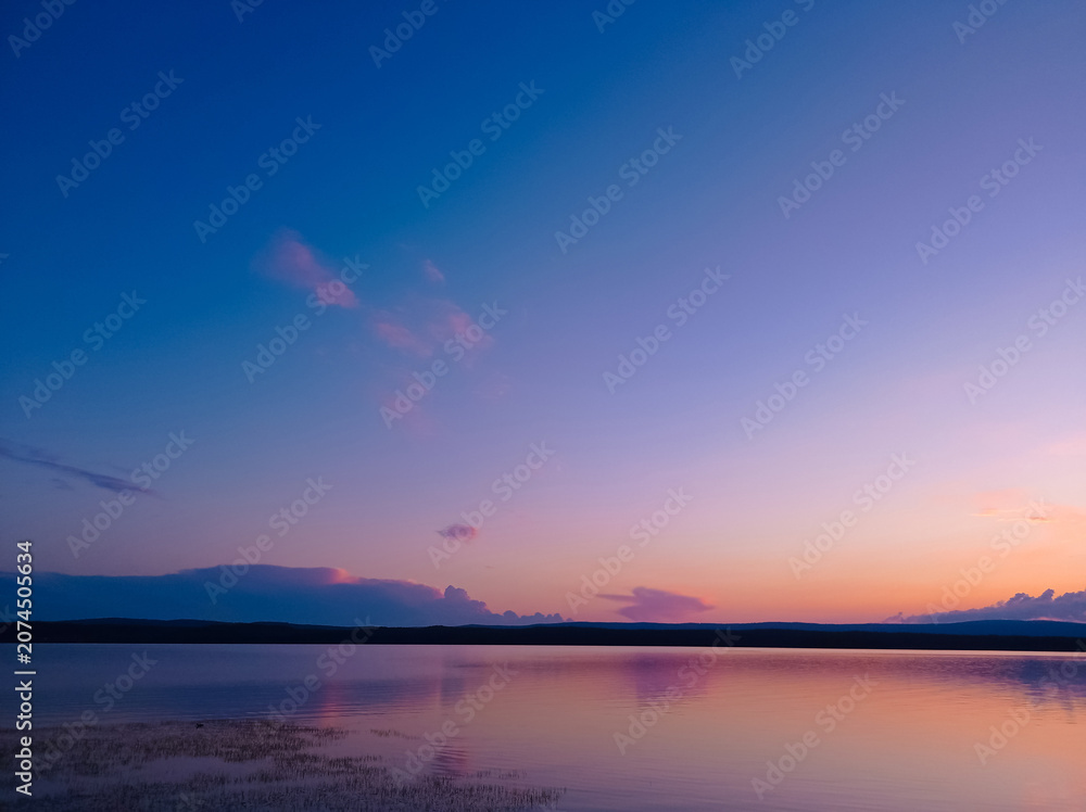 Fototapeta premium View of the beautiful pink sunset on the lake