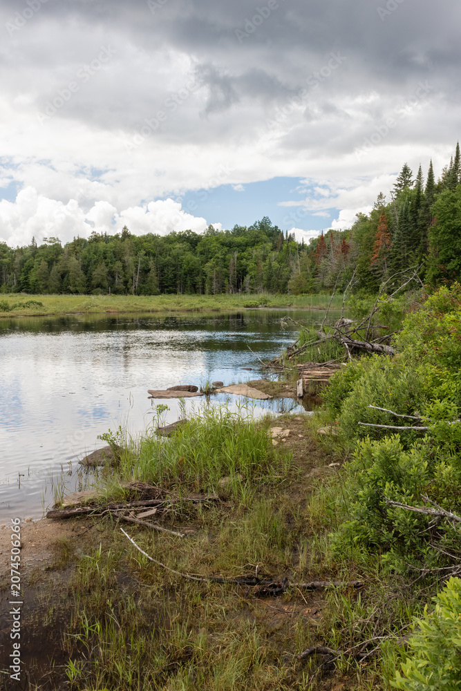 Fototapeta premium Sky clearing canoe launch site over Park Lake near Algonquin Park in Ontario in summer