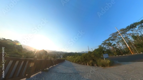 Paved walkway with wooden railing at sunrise outdoor recreation