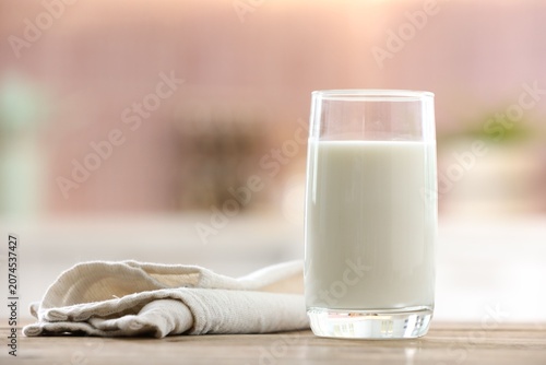 Konstfotografi Glass of fresh milk on wooden table in kitchen, closeup