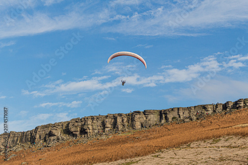 Paragliding over Stanage Edge near Hathersage Village, Peak District, Derbyshire, UK