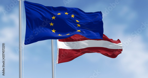 Cuadro en lienzo Flags of Latvia and the European Union waving on a clear day