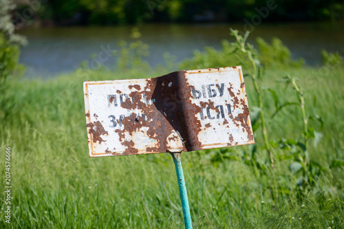 the sign of old rusty iron on the river bank.