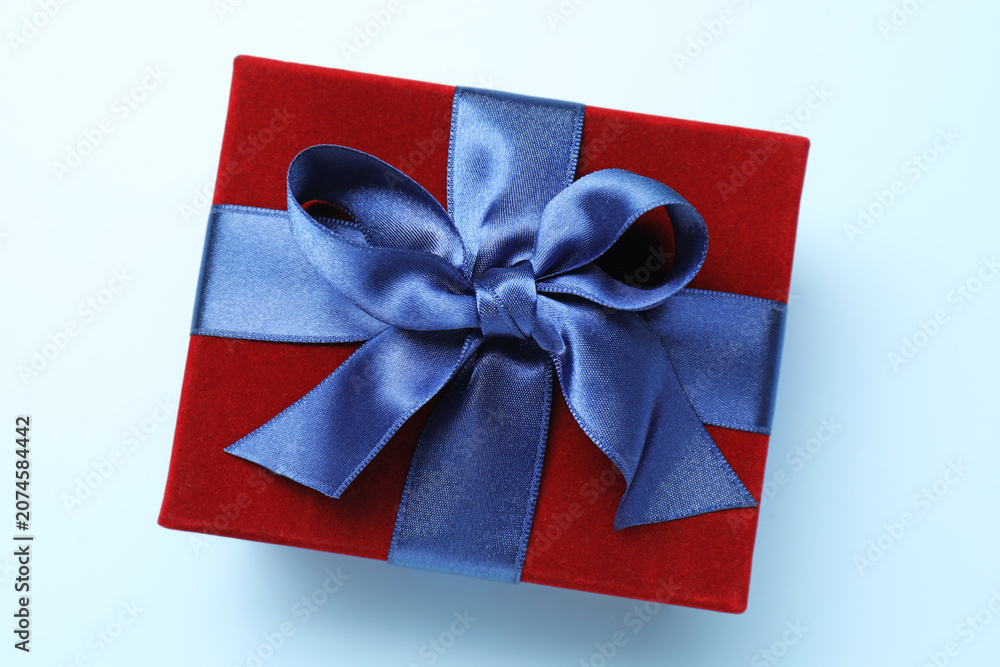 Fototapeta premium Beautiful velvet gift box on light blue background, top view