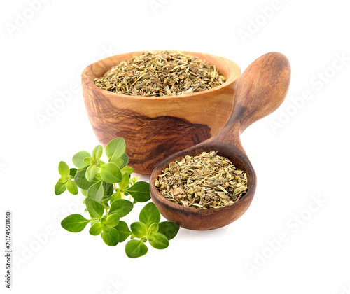 Oregano or marjoram leaves isolated on white background. Oregano fresh and dried in the wooden bowl.