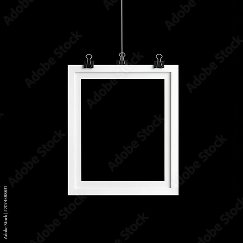 Minimalist White Picture Frame Hanging with Black Binder Clips Against a Plain Solid Black Background for Art Display