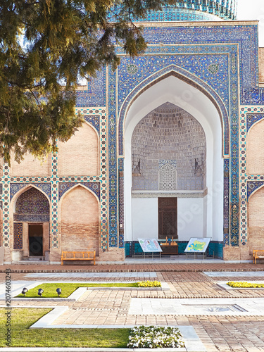 Gur-e-Amir mausoleum facade with ornate blue tilework and pointed arch iwan in Samarkand Uzbekistan. Historic Timurid architecture ideal for travel publications and cultural heritage projects.