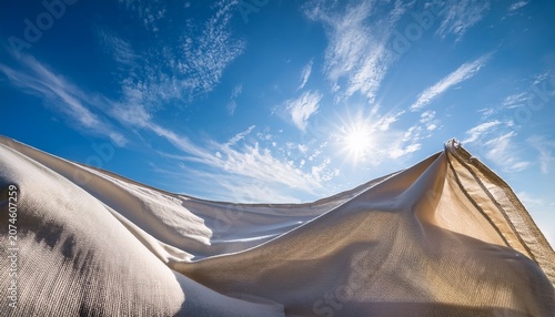 Flowing Linen Under Serene Blue Sky Exuding Freshness And Purity