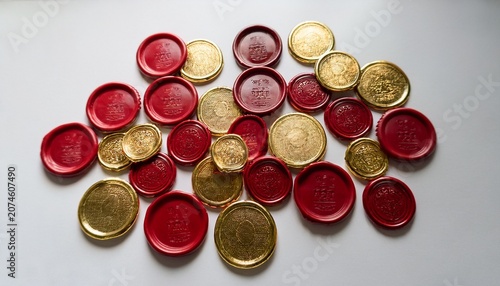 Red And Gold Wax Seals Scattered Across White Background Glossy Circular Impressions And Textured Edges Create Luxurious Vintage Stationery Mood Artisanal Branding And Invitation Concept Studiolit