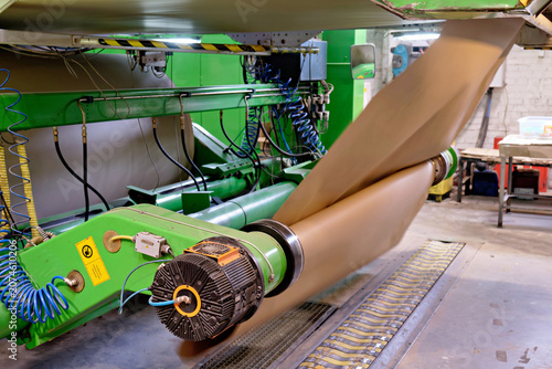 Принти на полотні Industrial production plant mechanism unwinding giant roll of paper raw material for manufacturing corrugated cardboard containers