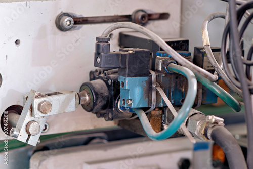Картината върху платно Detailed view of an industrial pneumatic control valve and actuator linkage installed on factory equipment showing technical connections