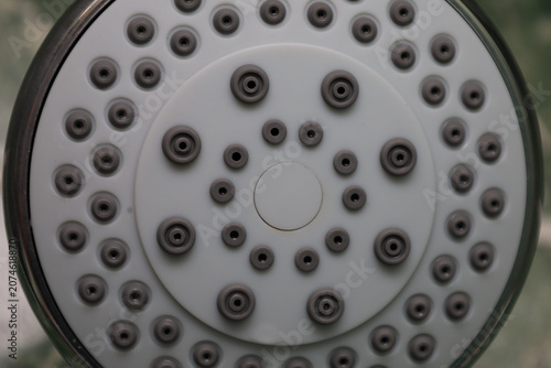 Obraz na plátně A modern round shower head with gray rubber nozzles is shown in a macro close-up view
