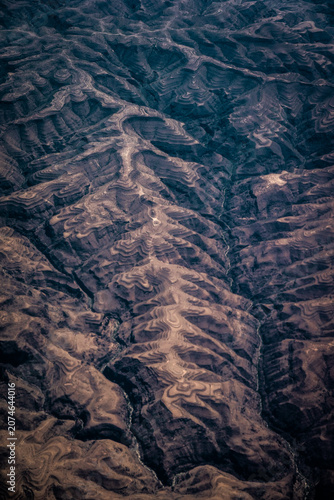 Aerial view of the rugged, terraced landscape featuring deep valleys and intricate soil patterns, Nairobi, Nairobi County, Kenya.