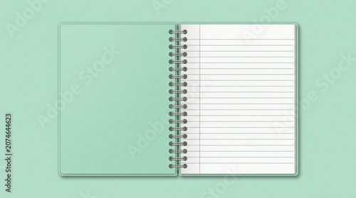 Spiral bound notebook with blank lined pages on green background