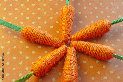 Yarn Woven Orange Carrots on an Orange Spotted Background