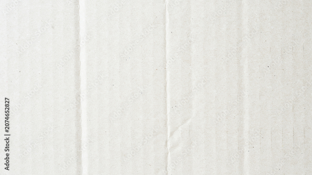 Fototapeta premium Close-up of corrugated cardboard texture, white cardboard background, industrial packaging material, detailed paper surface