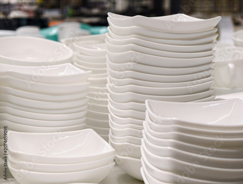 Ceramic tableware plates bowls and salad bowls shown in stacked retail presentation