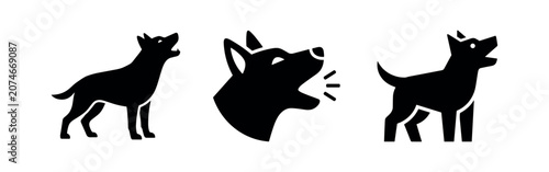 Foto Three black silhouettes of dogs barking or howling on a white background