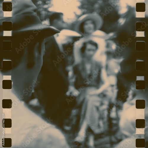 Vintage blurred 35mm film photo of women in summer hats at an outdoor garden gathering