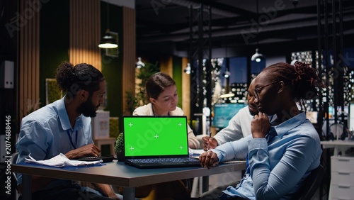 Fotografía Green screen mockup laptop used by staff members in modern inclusive office, Coworkers presenting team leader key data statistics on chroma key isolated screen device after business audit