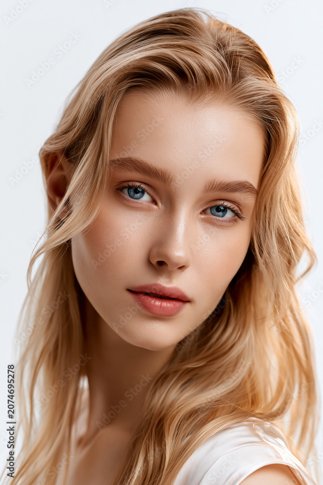 Fototapeta premium natural beauty portrait of elegant blonde woman, closeup portrait of beautiful blonde female with blue eyes, sophisticated young blonde woman with minimal makeup