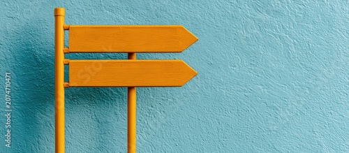 Two blank orange arrow signs point in opposite directions on a textured blue background