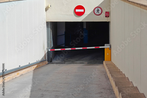 Konstfotografi View of parking garage entrance with barrier and no entry signs