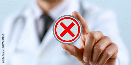 Doctor holding a red 'X' symbol, indicating a mistake or denial