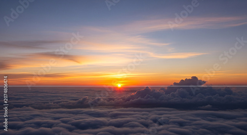 Vibrant Sunset Horizon over Expansive Cloudscape with Golden and Purple Hues