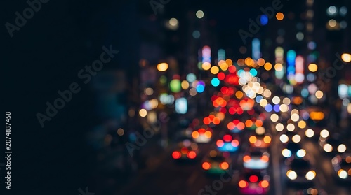Blurred city traffic lights at night with colorful bokeh effect