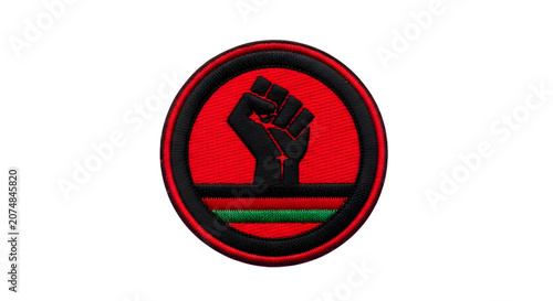 A raised fist emerges from a red circle with black and green stripes