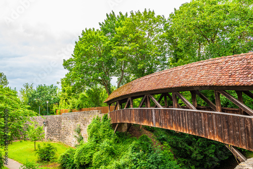 Wooden covered bridge by city wall in Rothenburg ob der Tauber